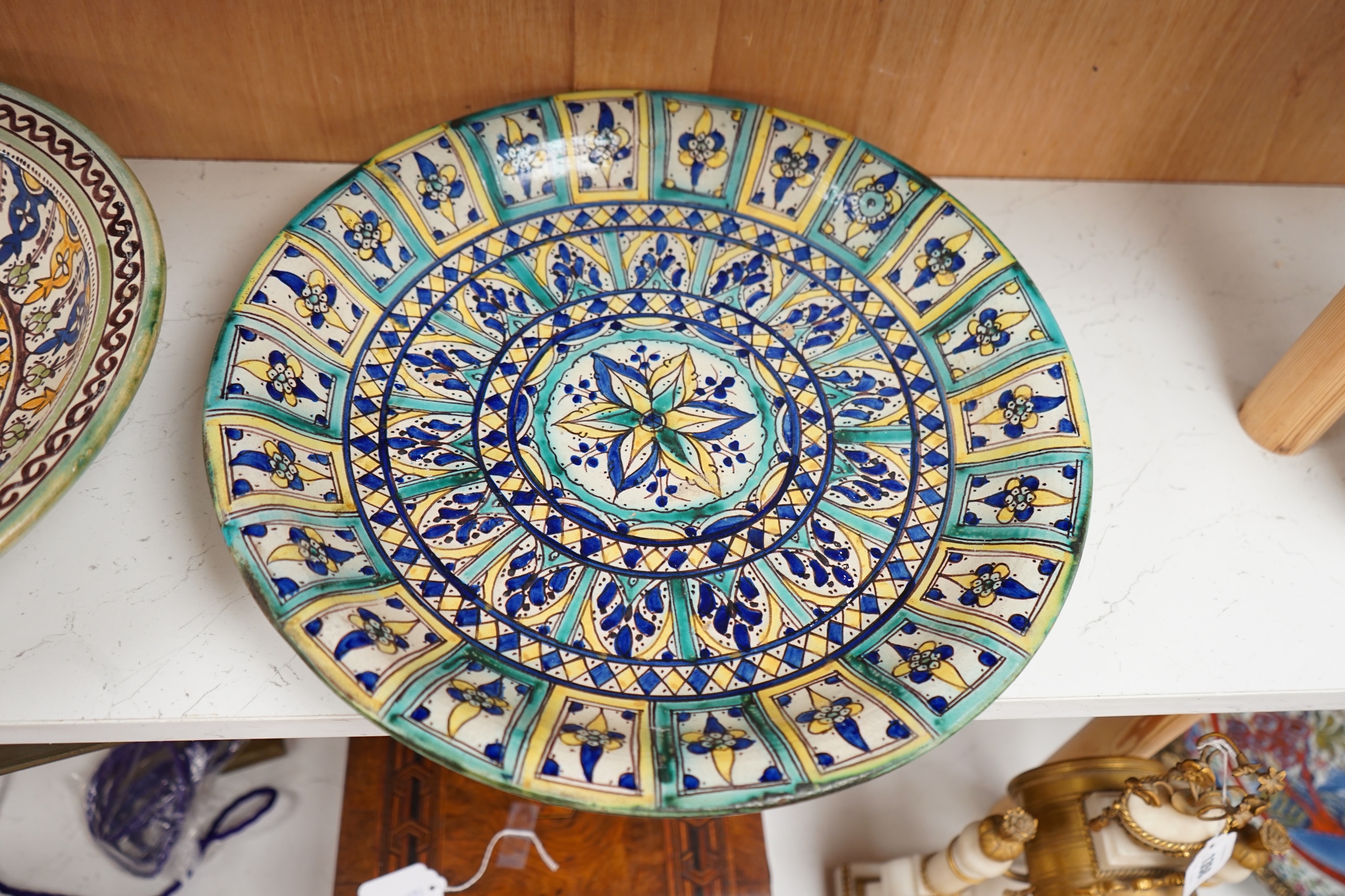 Two 19th/20th century Moroccan polychrome pottery dishes, 41cm diameter. Condition - fair to good